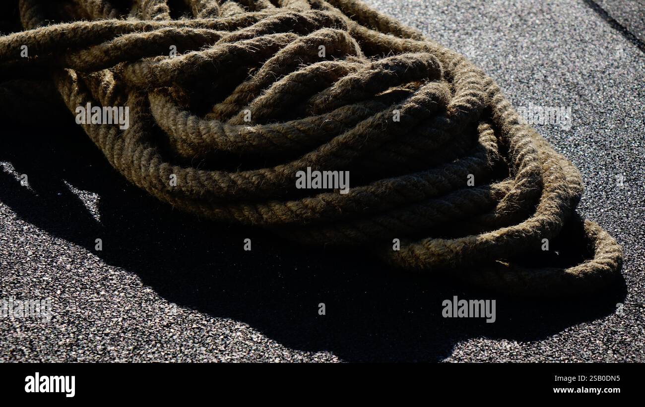 collected rope at the construction site on the black background Stock ...