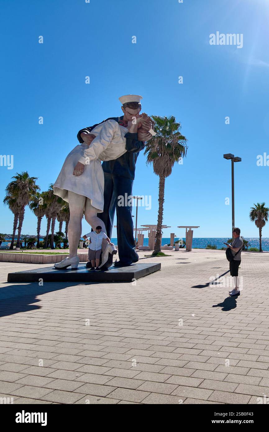 Civitavecchia, Italy, January 31, 2025: World War II Kiss Statue. This iconic sculpture depicts a sailor embracing a nurse in a celebratory kiss. Tour Stock Photo