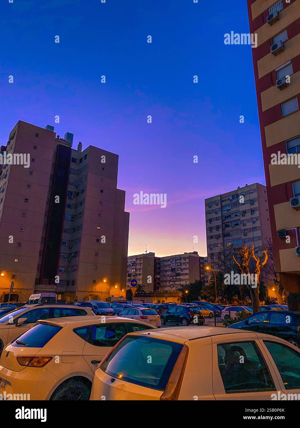 Urban purple sunset : cityscape apartment and parking lot car - Smartphone Captured Stock Image