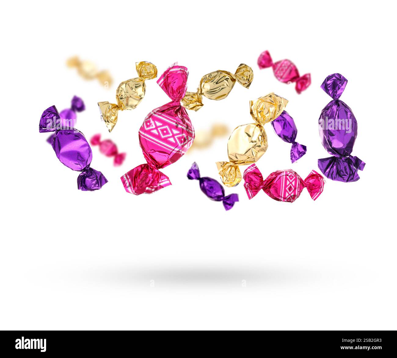 Candies in bright wrappers falling on white background Stock Photo