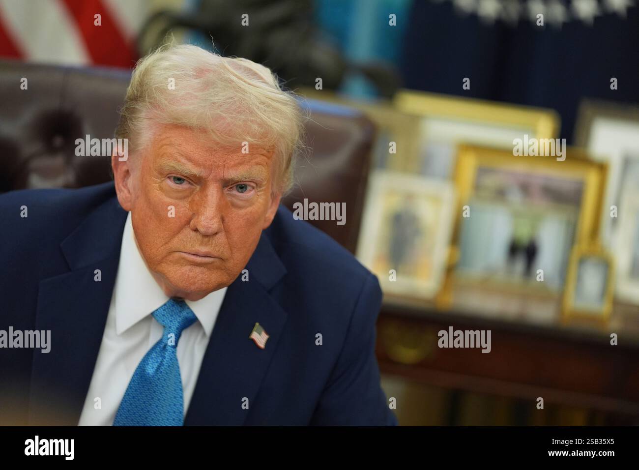 President Donald Trump speaks to reporters as he signs executive orders