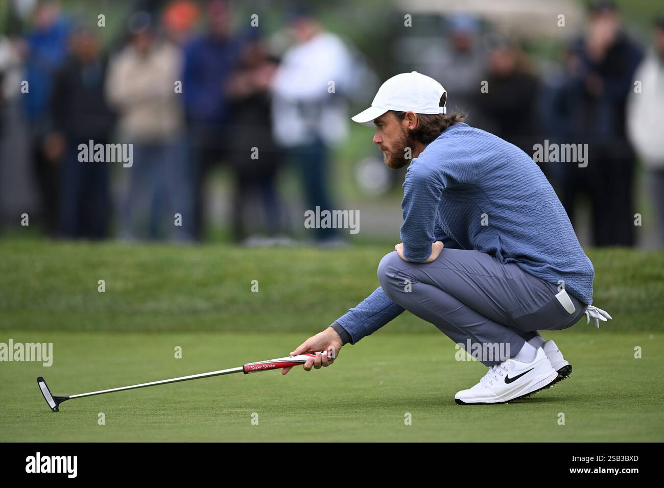 Tommy Fleetwood lines up a putt on the sixth hole at Pebble Beach Golf