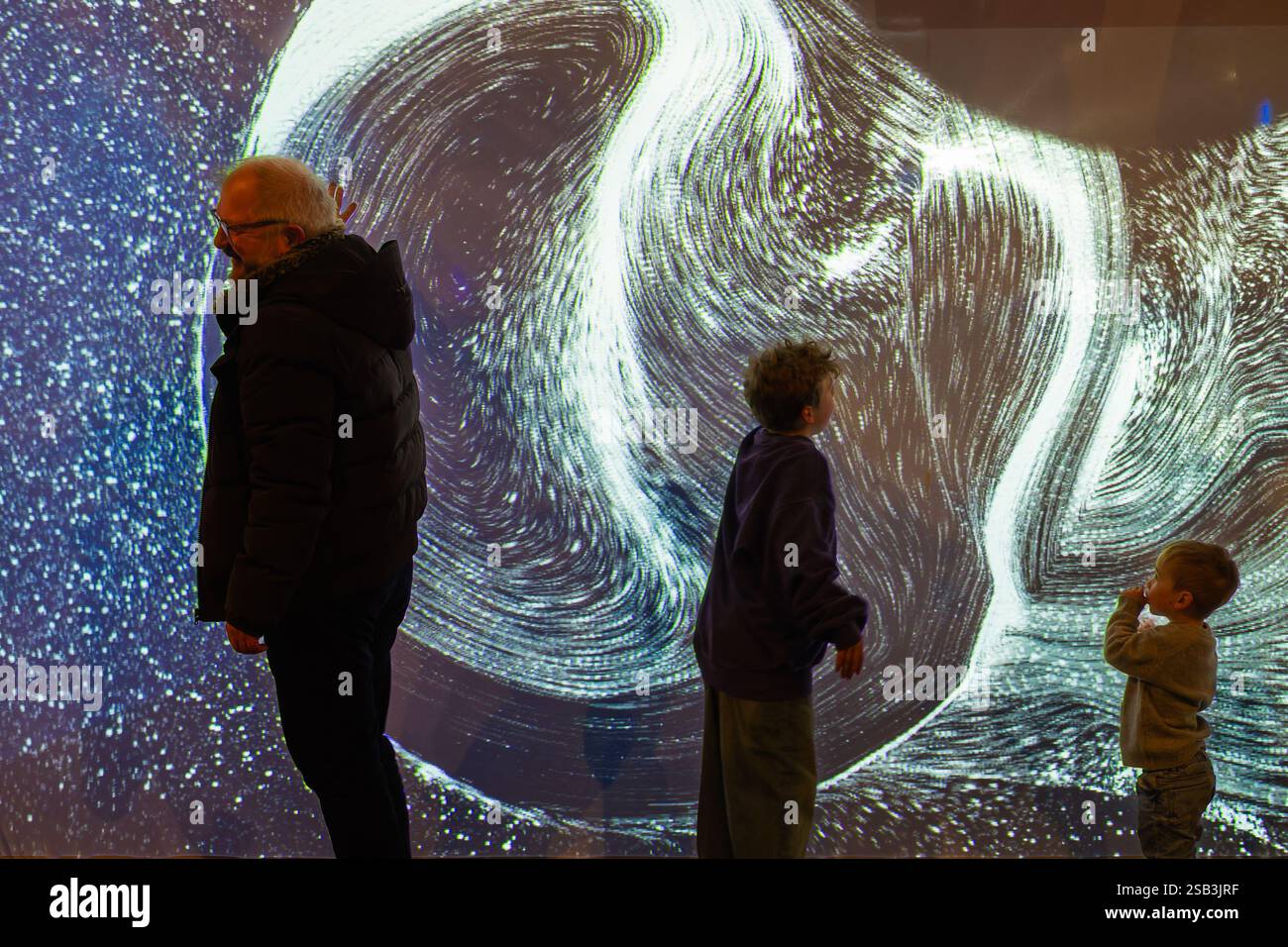 Bristol, UK. 31st Jan, 2025. People are pictured as they interact with the light installation titled 'Tetra' by Ottomata in The Podium, Broadmead. Tetra is an audio-visual experience inspired by the cosmos and the many forces of nature that invites audiences to control the visuals and sounds of the installation by using their entire bodies to interact with it. Ottomata formed in Montreal in 2017, is a studio that specialises in interactive media for the public space in order to create truly immersive experiences. Credit: Lynchpics/Alamy Live News Stock Photo