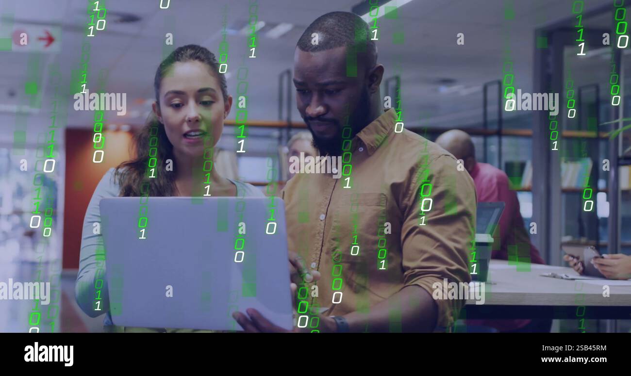 Binary code image over diverse business people working on laptop in office Stock Photo