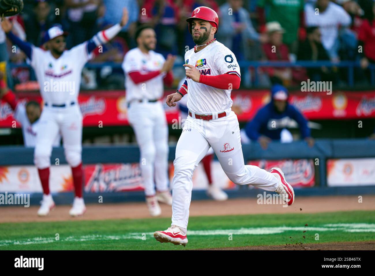 Dominican Republic's Jose Marmolejos runs toward home plate to score
