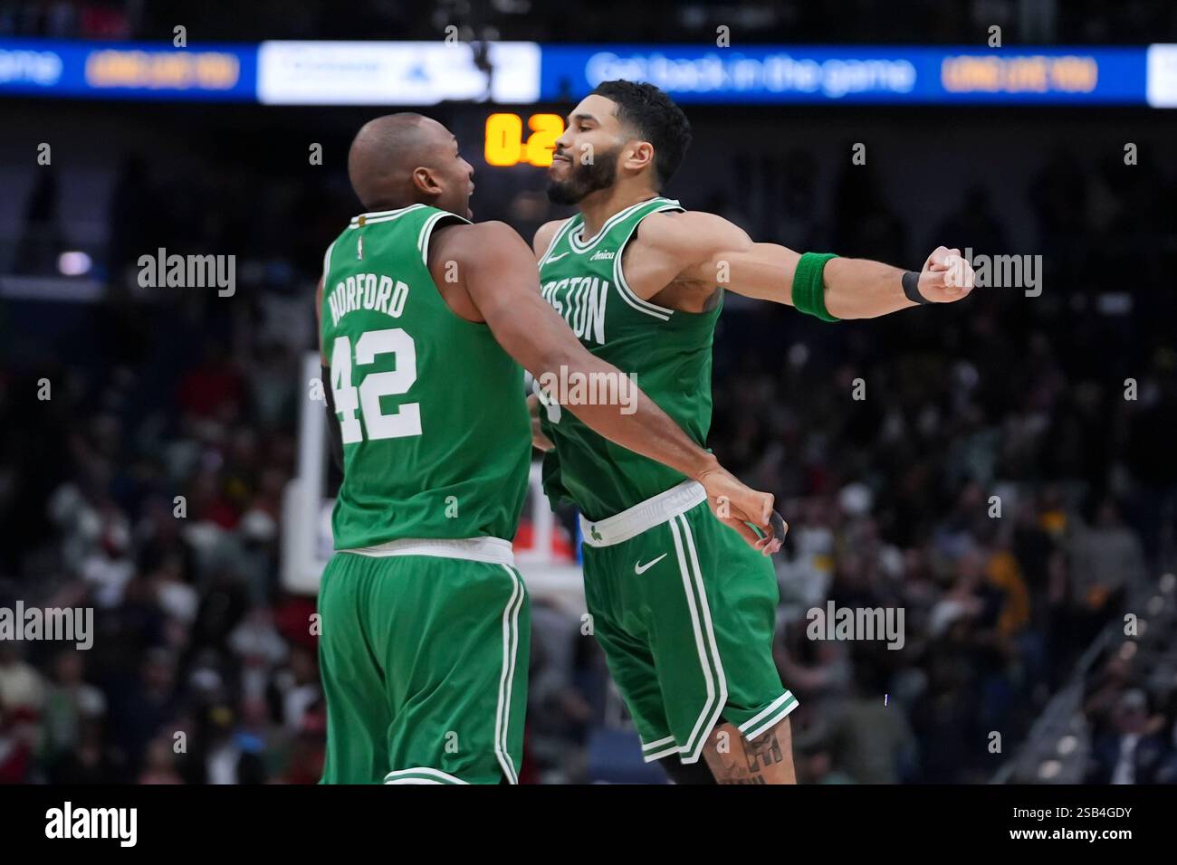 Boston Celtics forward Jayson Tatum (0) celebrates with center Al