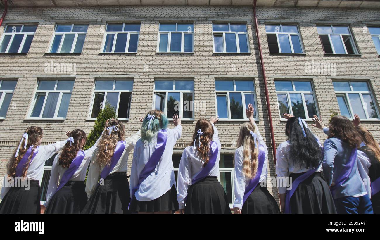 Graduating students saying farewell to their school and celebrating the ...