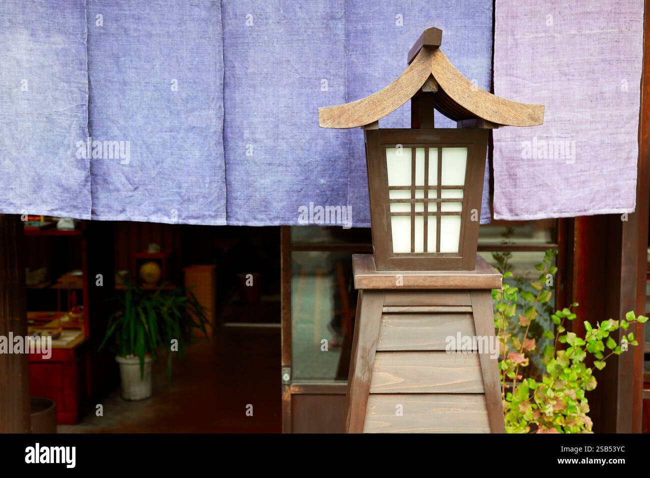 Traditional japanese wooden lantern in front of temple Stock Photo