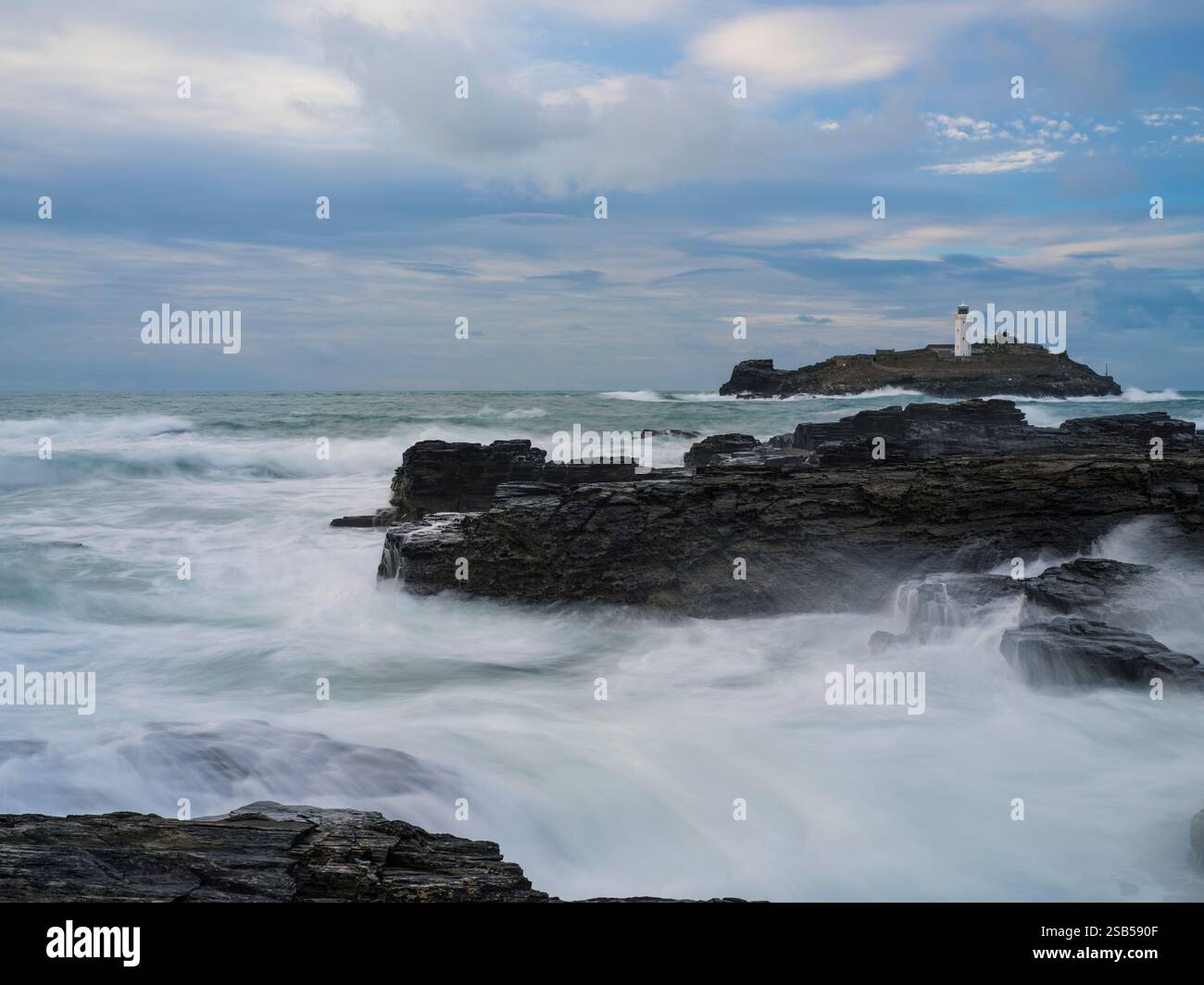 GODREVY ROCKS AND ROUGH SEA WAVES BREAKING OVER ROCKS Stock Photo - Alamy