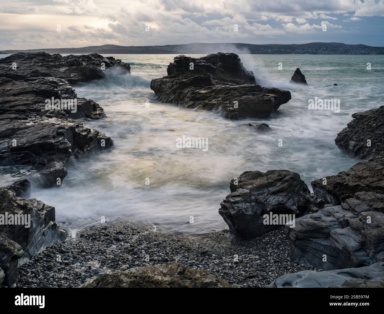 GODREVY ROCKS AND ROUGH SEA WAVES BREAKING OVER ROCKS Stock Photo - Alamy