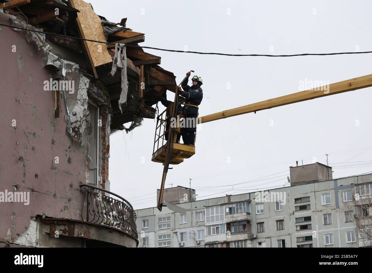 Rescue workers clear the rubble of a building damaged by a Russian ...