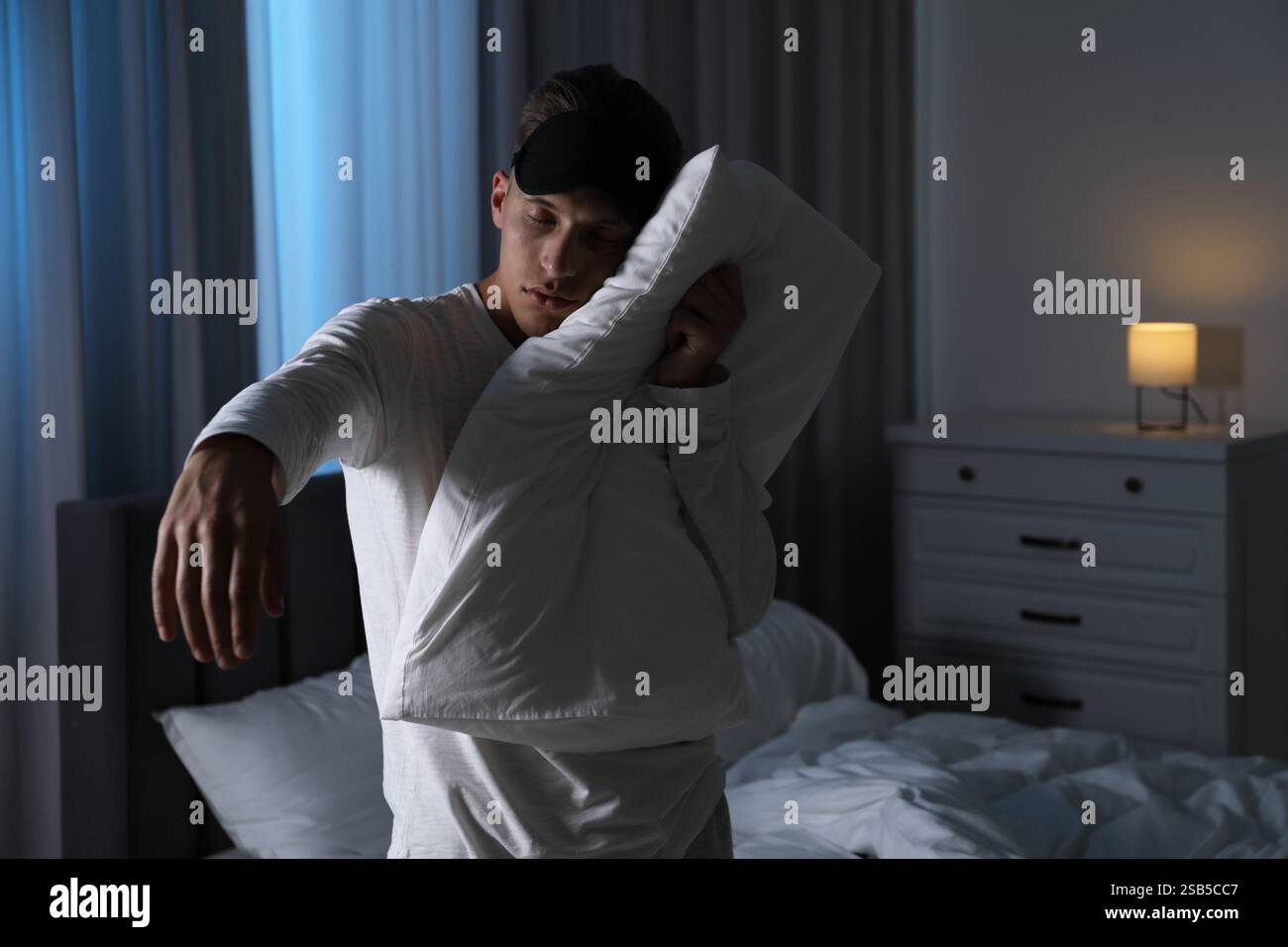 Young man suffering from sleepwalking at home Stock Photo