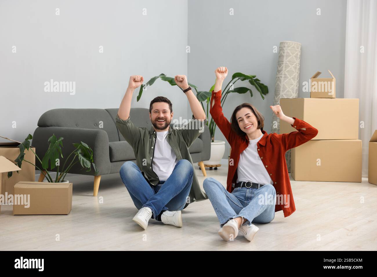 Moving day. Happy couple having fun in their new home Stock Photo - Alamy