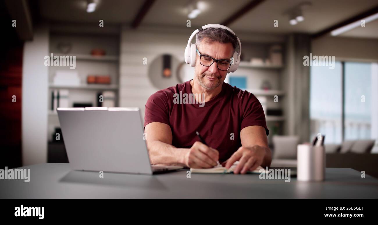 College Teacher At Home Using Laptop Computer Stock Photo