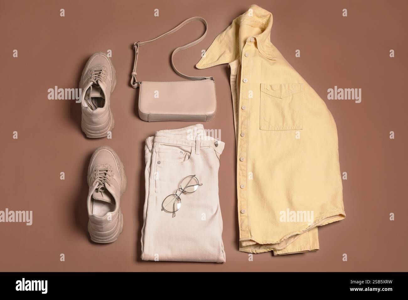 Stylish outfit with bag on mocha mousse shade background, flat lay ...