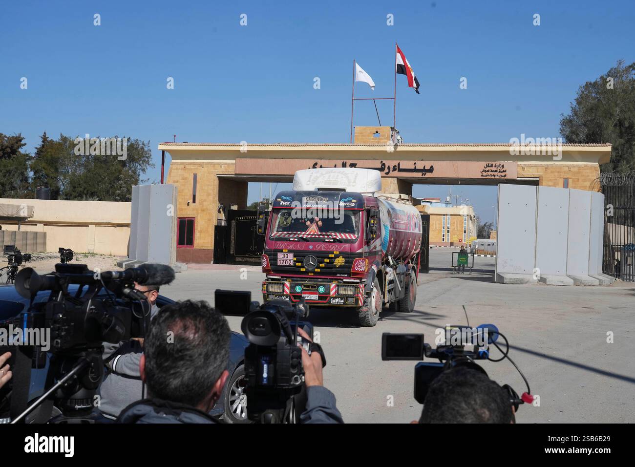 Cameramen film a returning water truck at Rafah border crossing, Egypt ...