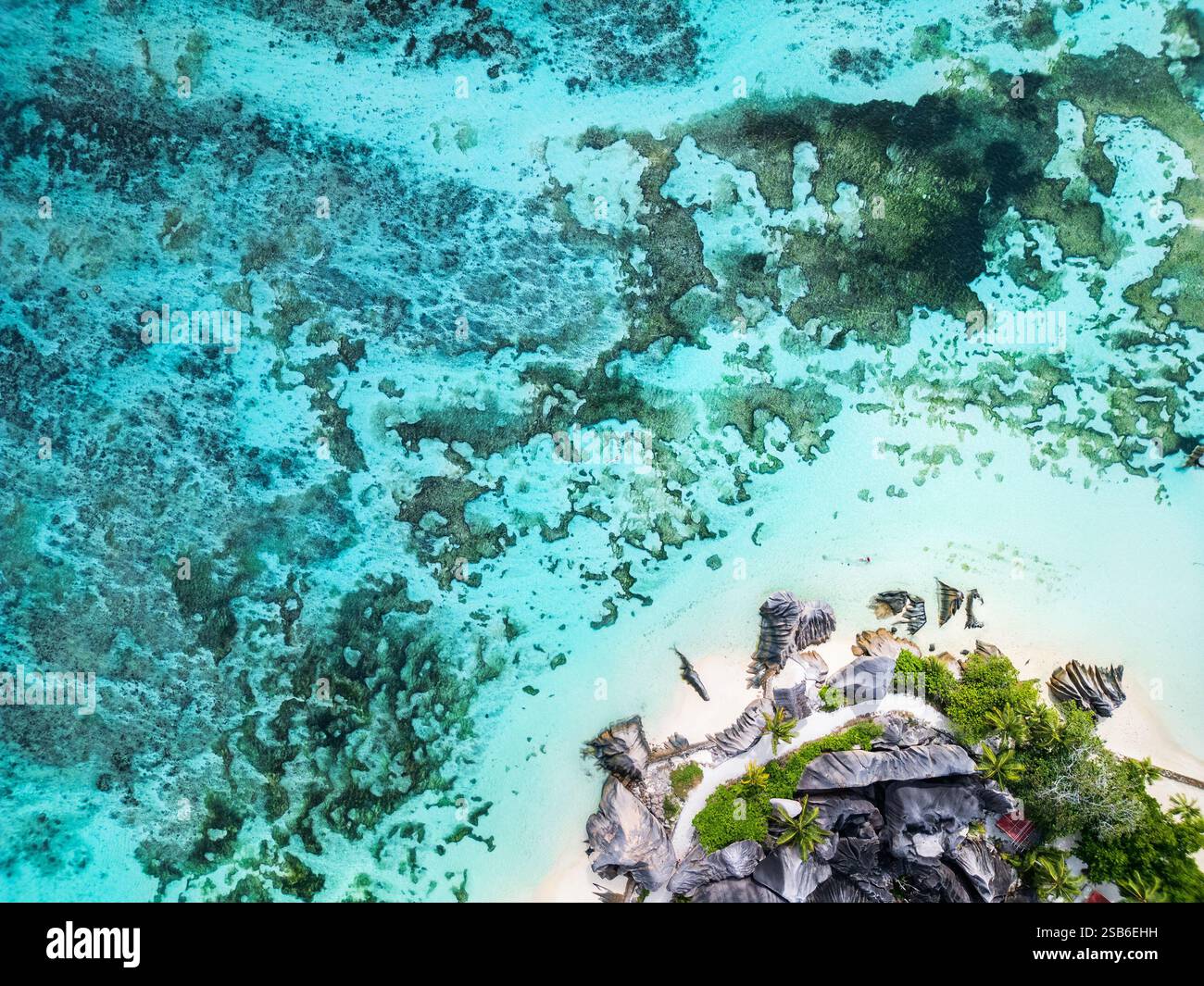 Aerial view of Anse Source D'Argent, showcasing turquoise waters, coral formations, and large granite rocks along the white sandy coastline on La Digu Stock Photo
