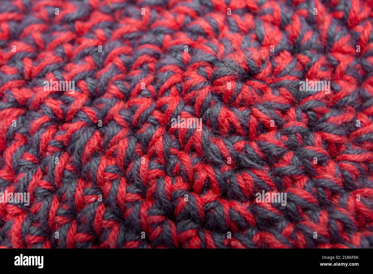 Knitted with a crochet hook, spiral shaped pattern texture, abstract   backdrop Stock Photo