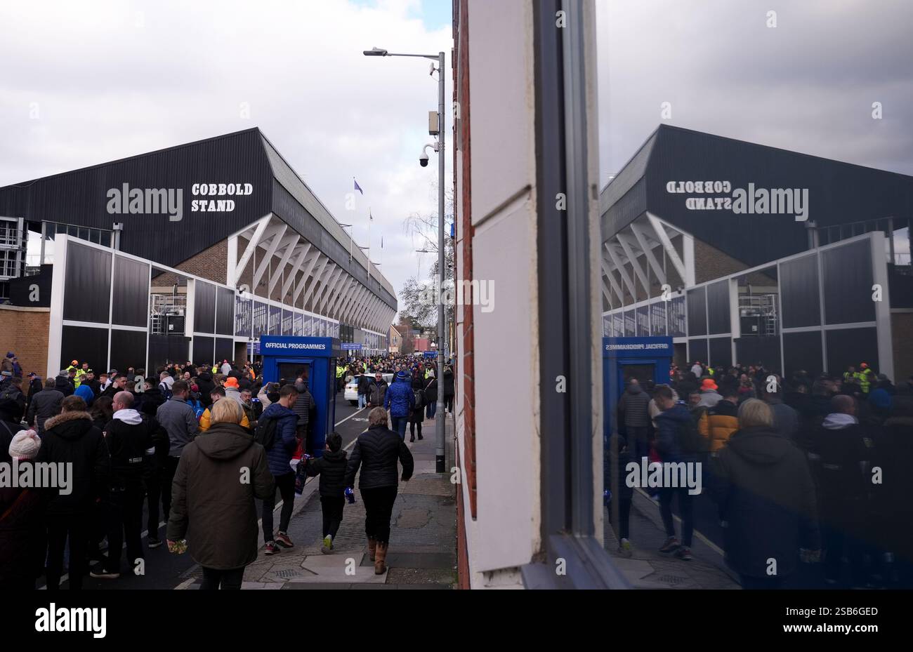 Fans make their way to the stadium before the Premier League match at