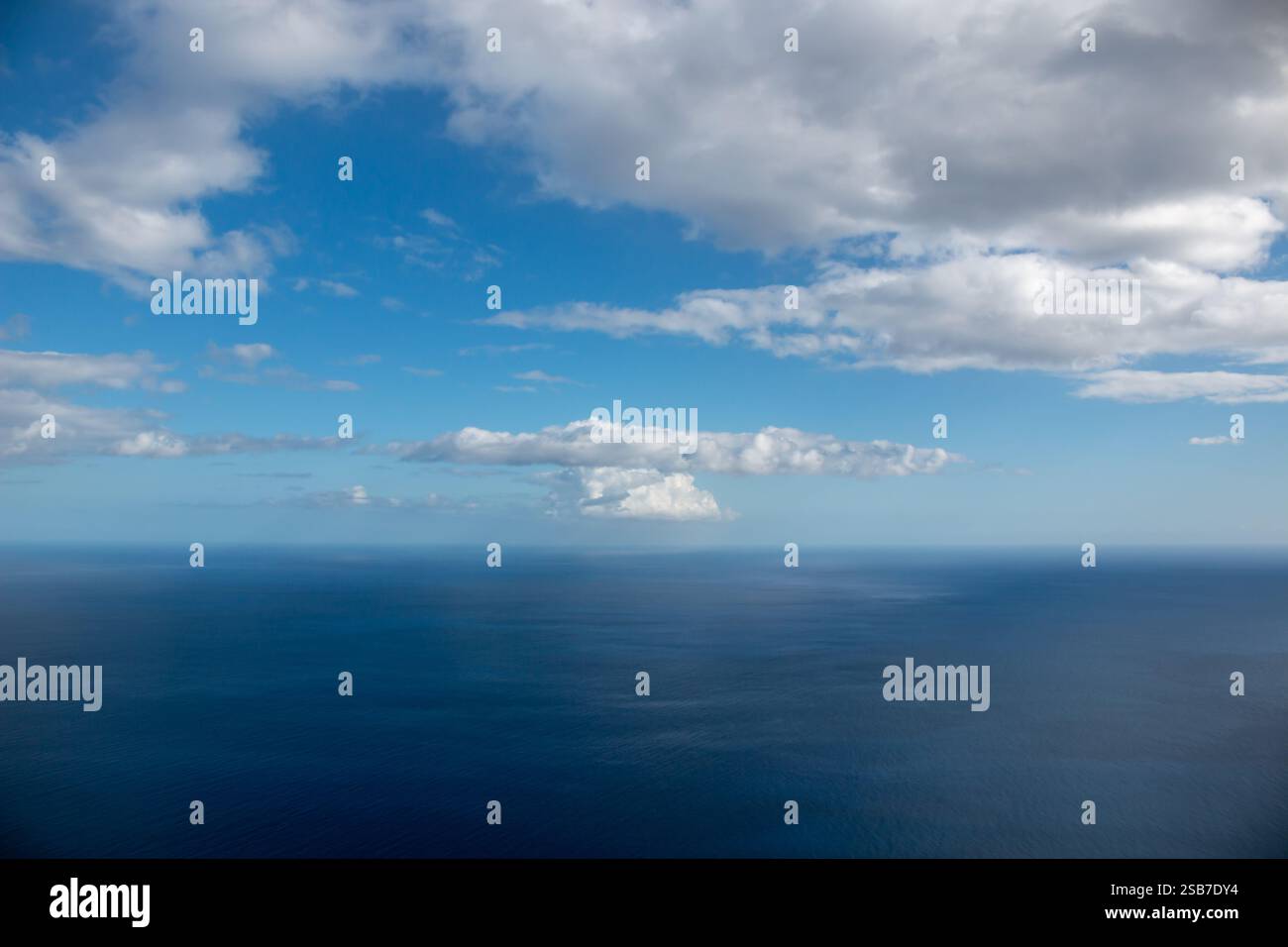 View from a mountain on the water of Atlantic ocean. Blue sky with ...