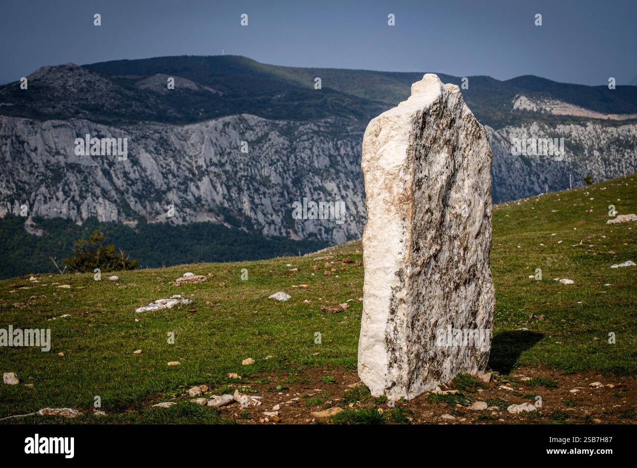 Arrizazen menhir, with the mountains of the Aizkorri-Aratz Natural Park ...