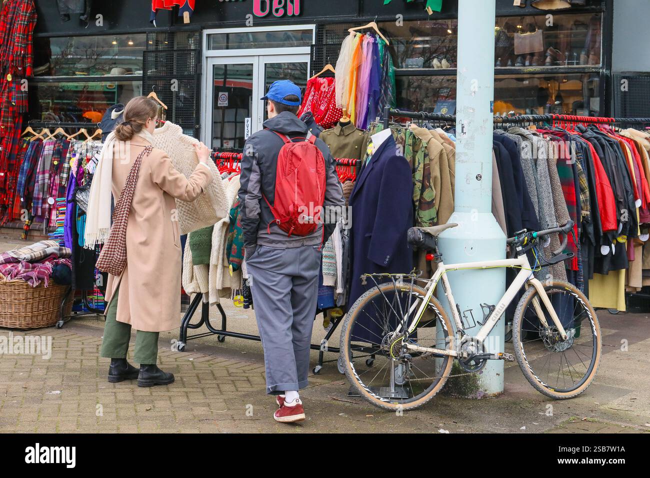 Man and woman looking to buy clothes from a secondhand boutique ...
