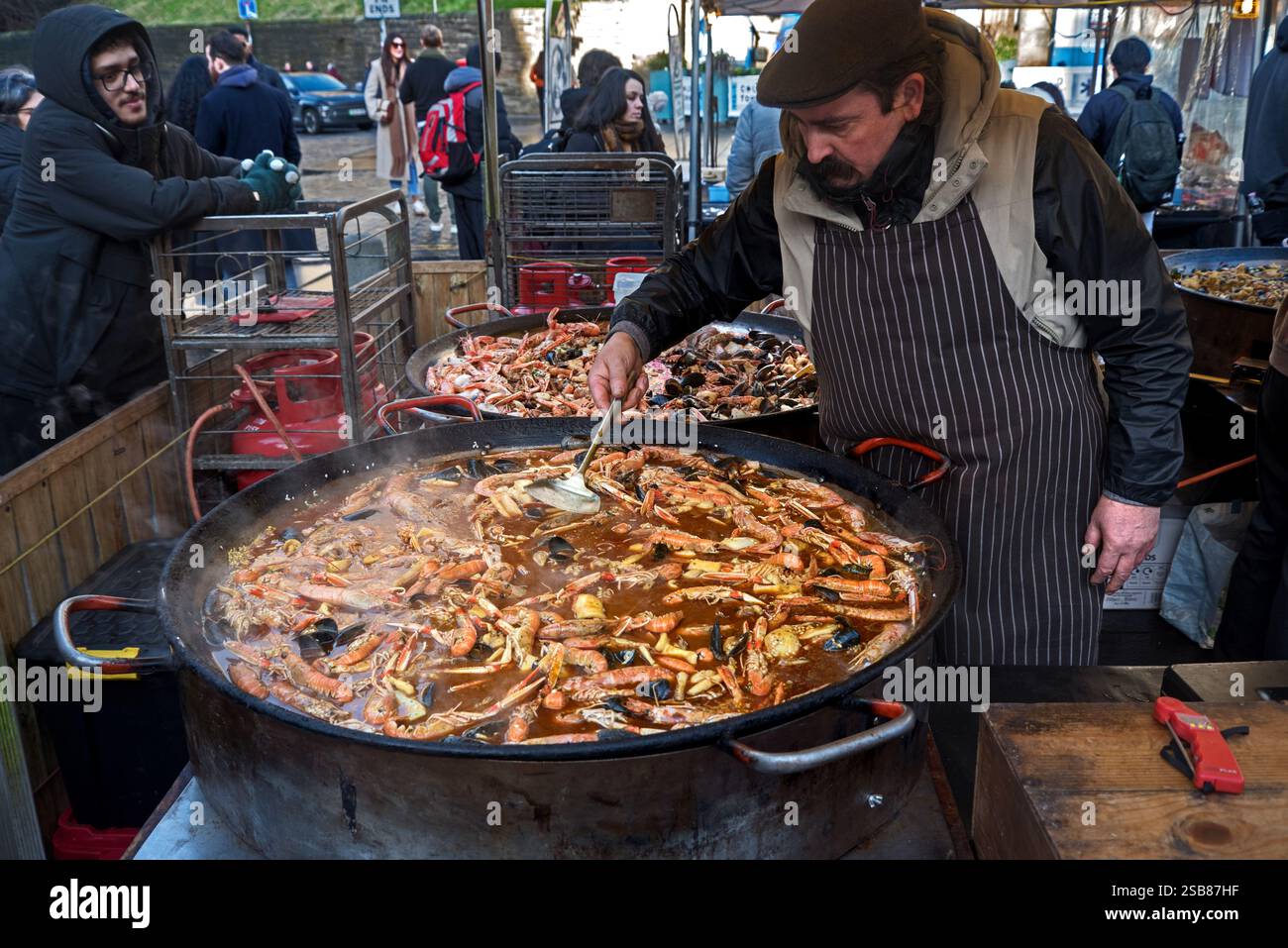 Paella cooking in large pans at the Saturday Market in the Grassmarket, Edinburgh, Scotland, UK. Stock Photo