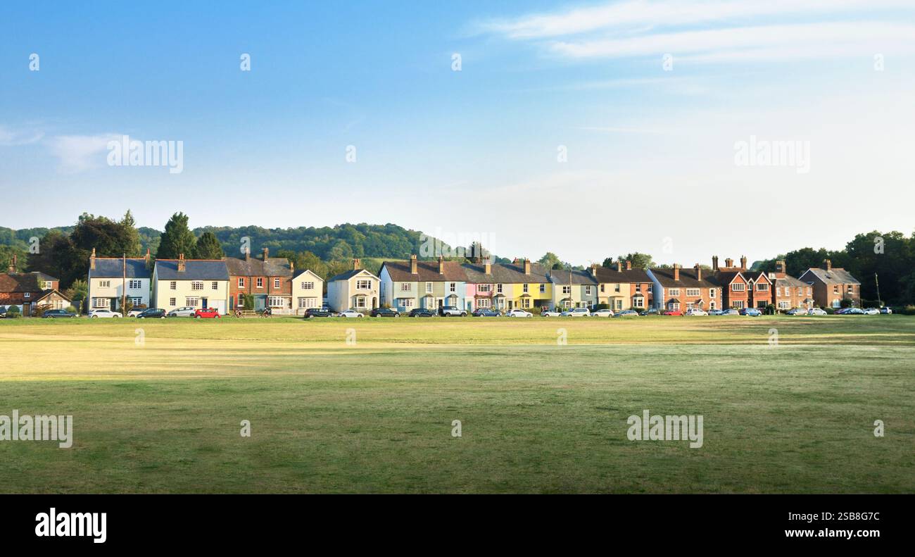 A row of charming colourful terraced houses painted in pastel colours overlooking the green on the edge of Reigate Heath in Surrey, England, UK Stock Photo