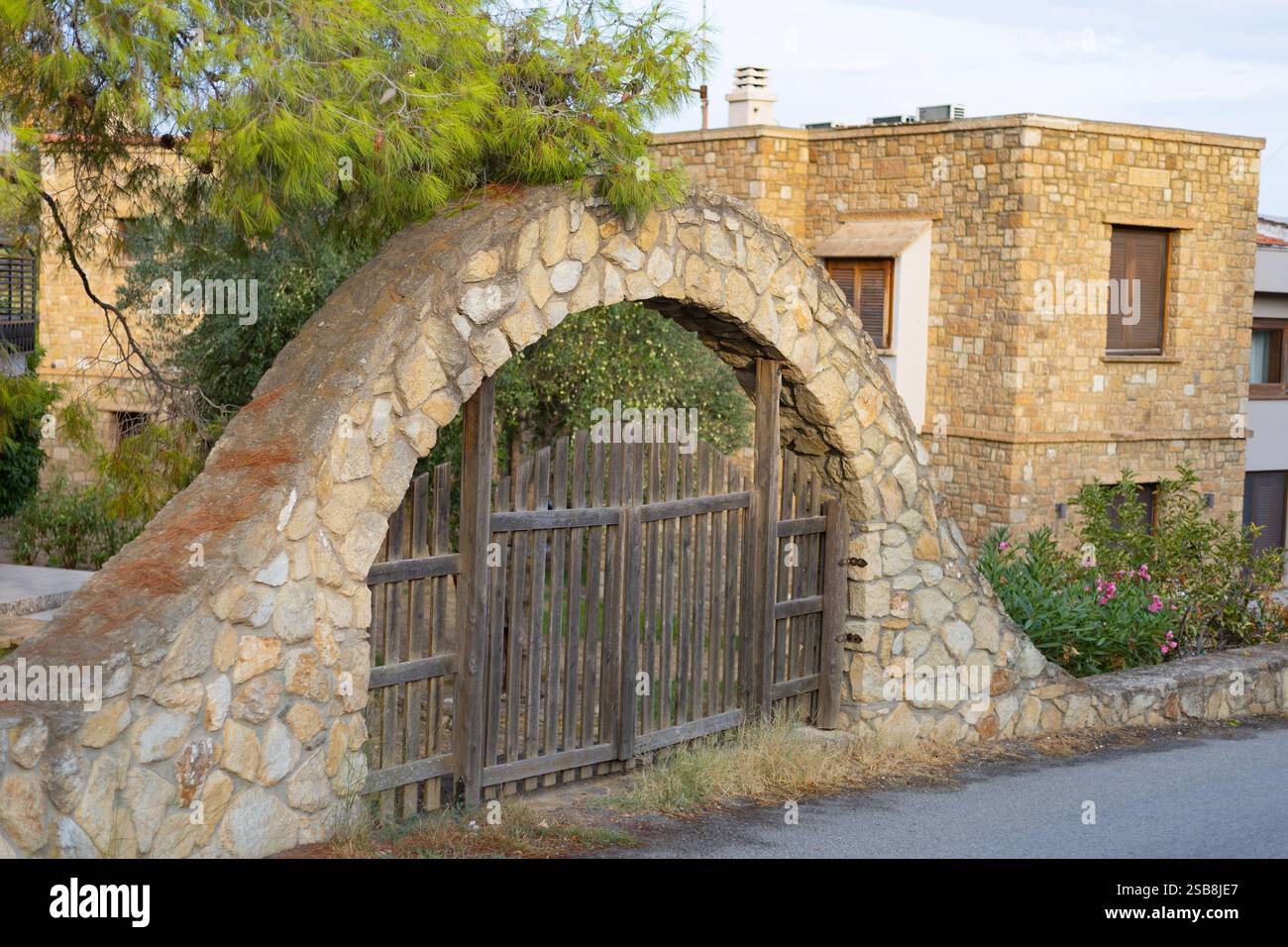 wooden gate in a stone arch, entrance to the courtyard of the house ...