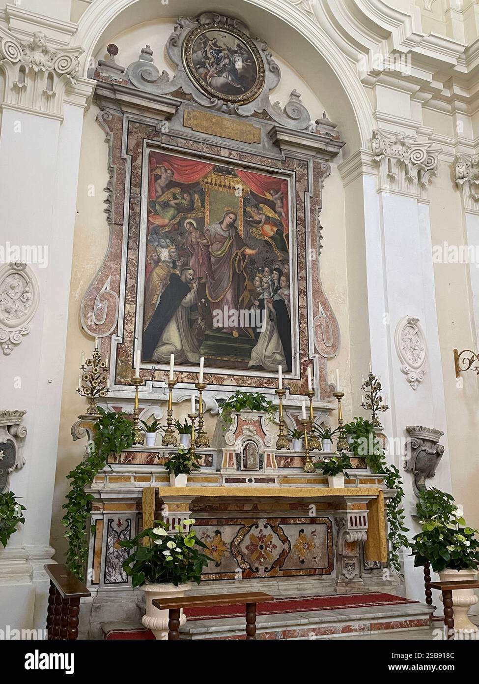 Nardo, Italy. Interior of the 16th century Church of Saint Dominic. The altar dedicated to Madonna del Rosario, with an oil painting from 1604. - Smartphone Captured Stock Image