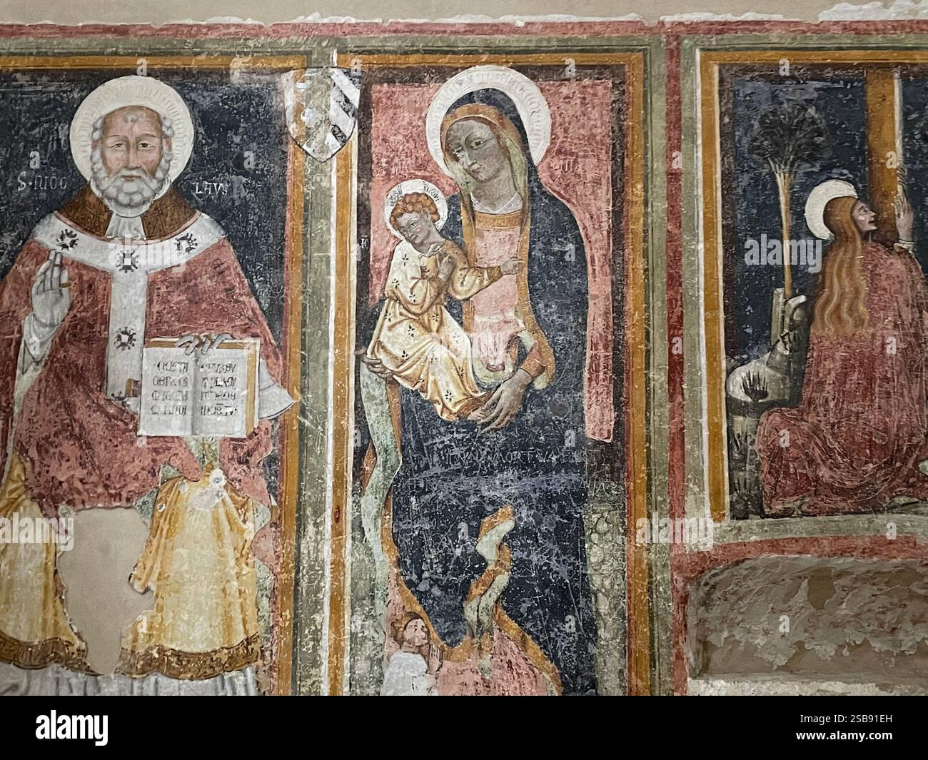 Nardò, Italy. Triptych inside the Cathedral of Santa Maria Assunta depicting St. Nicholas, Madonna with child, & St. Magdalene. - Smartphone Captured Stock Image
