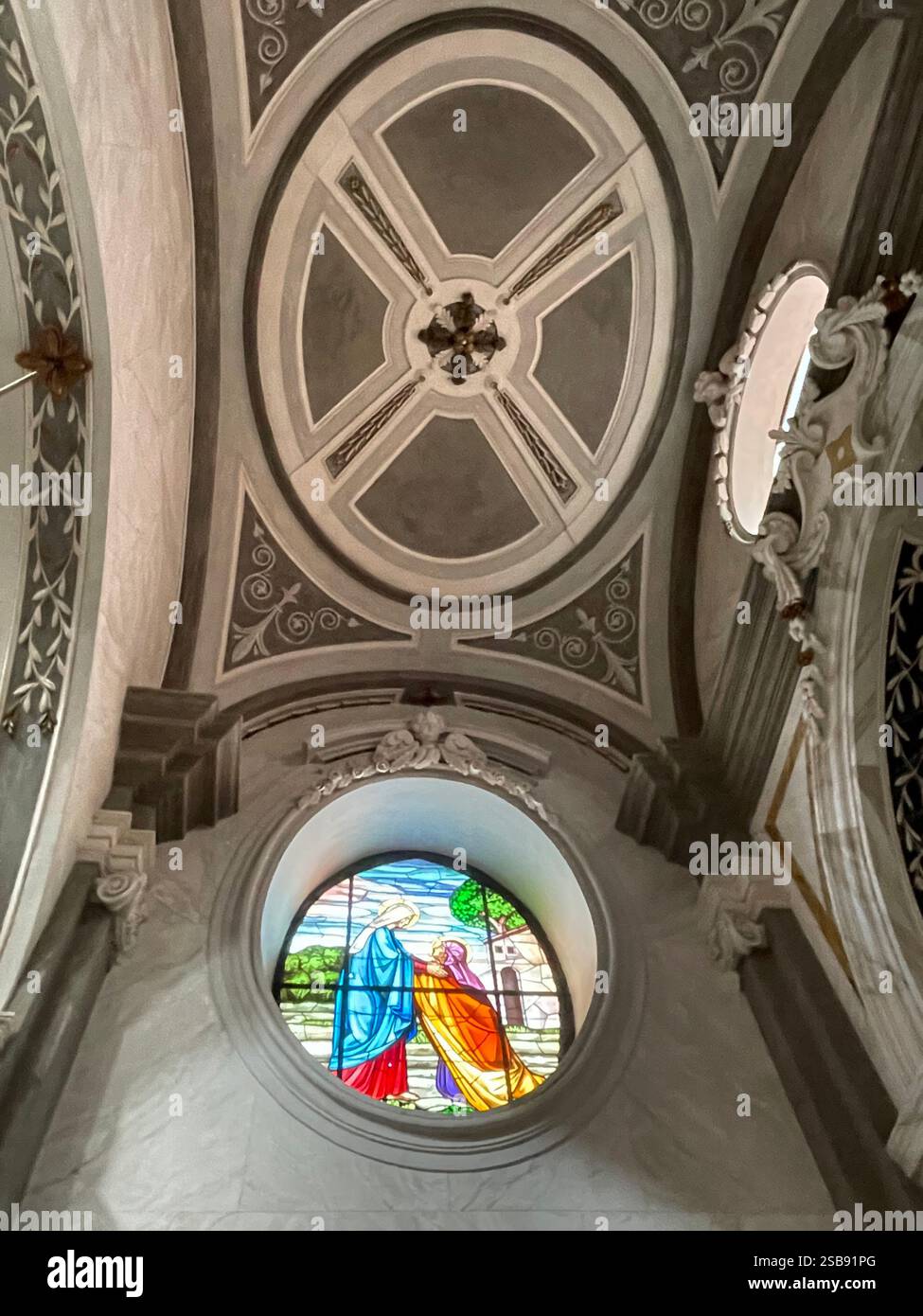 Noci, Italy. Interior of the medieval Church of Saint Mary and Saint Roch (Chiesa madre). Stained glass depicting the Visitation. - Smartphone Captured Stock Image