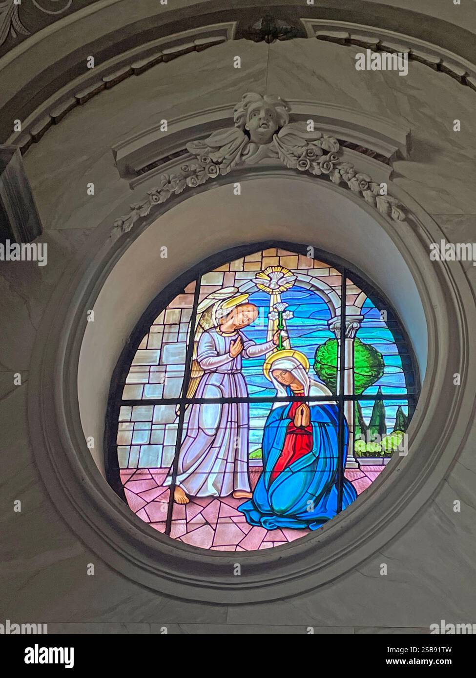 Noci, Italy. The Annunciation, stained glass scene inside the medieval Church of Saint Mary and Saint Roch (Chiesa madre). - Smartphone Captured Stock Image