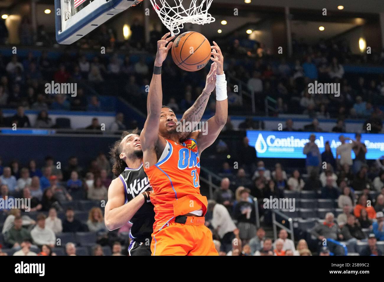 Oklahoma City Thunder guard Aaron Wiggins, front, grabs a rebound ...