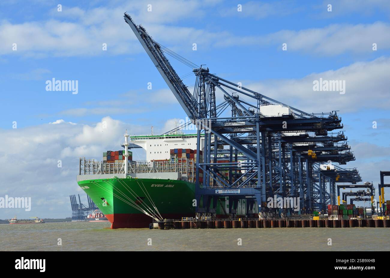 Container ship docked at port with gantry cranes loading containers hi ...