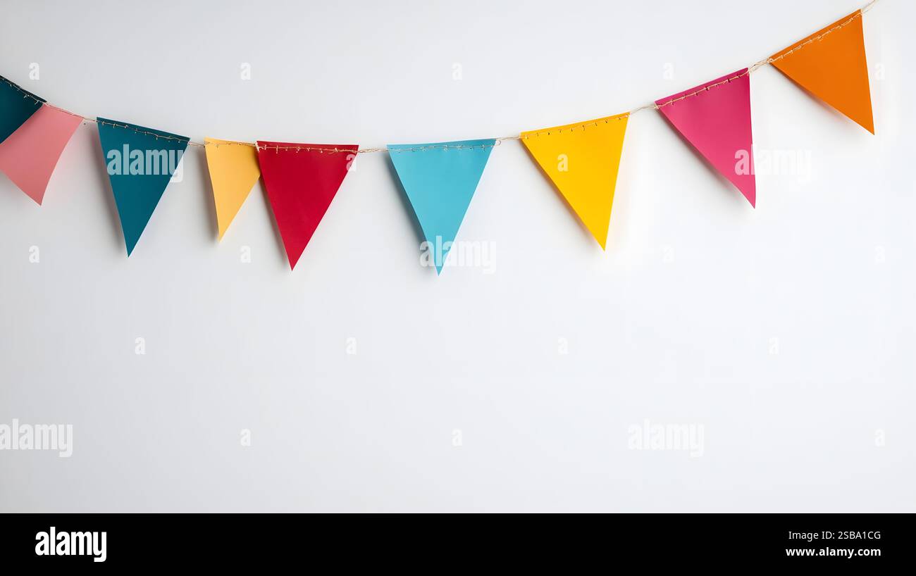 Colorful bunting flags hanging on a plain white wall in a studio ...