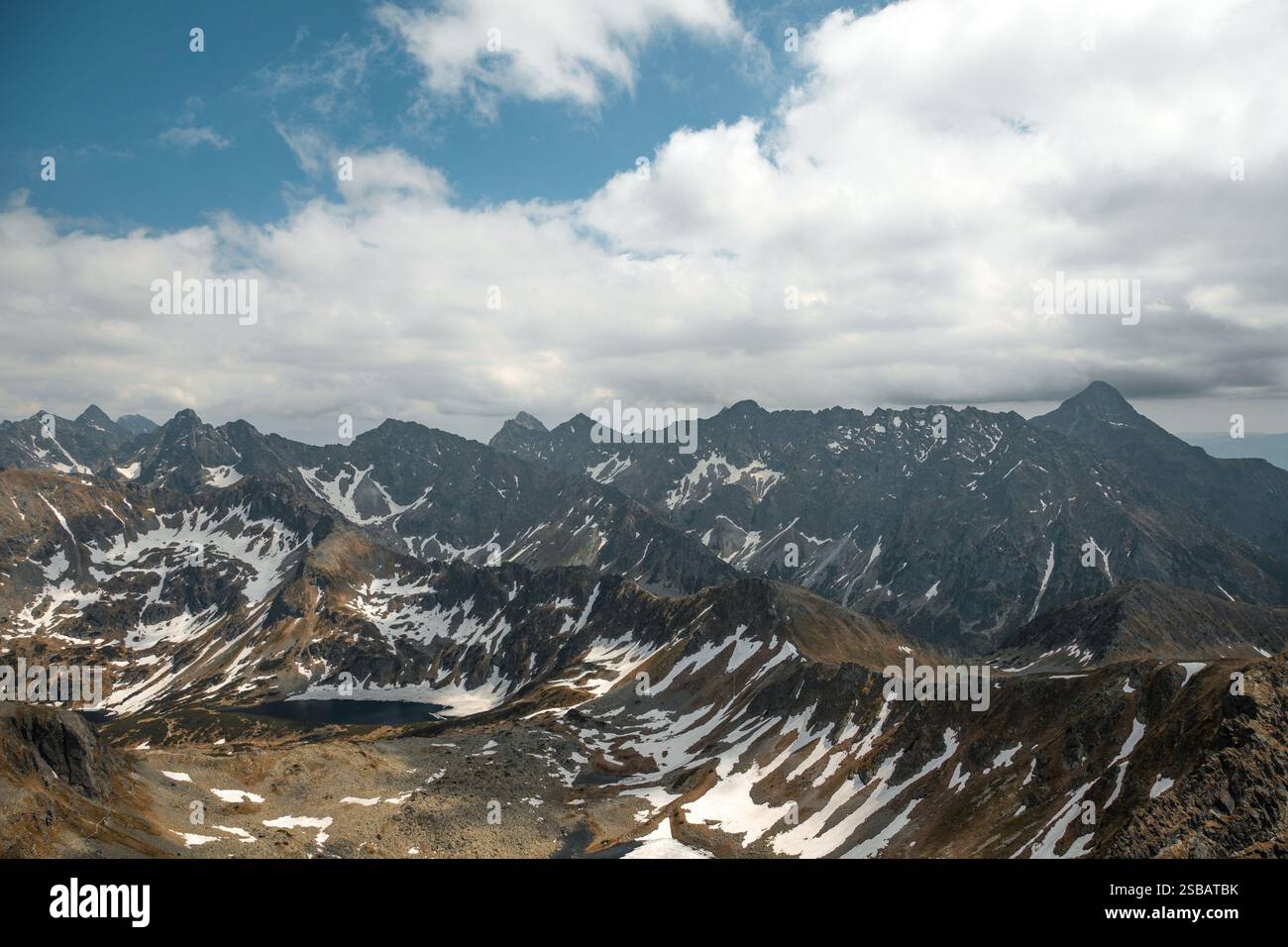 Western Tatra Mountains landscape with lakes from Świnica, Poland on a sunny, partially cloudy day in June Stock Photo