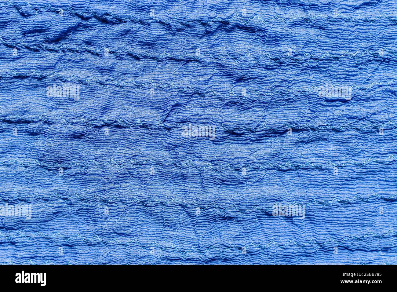 textile background made of crinkled stitched blue silk fabric Stock Photo