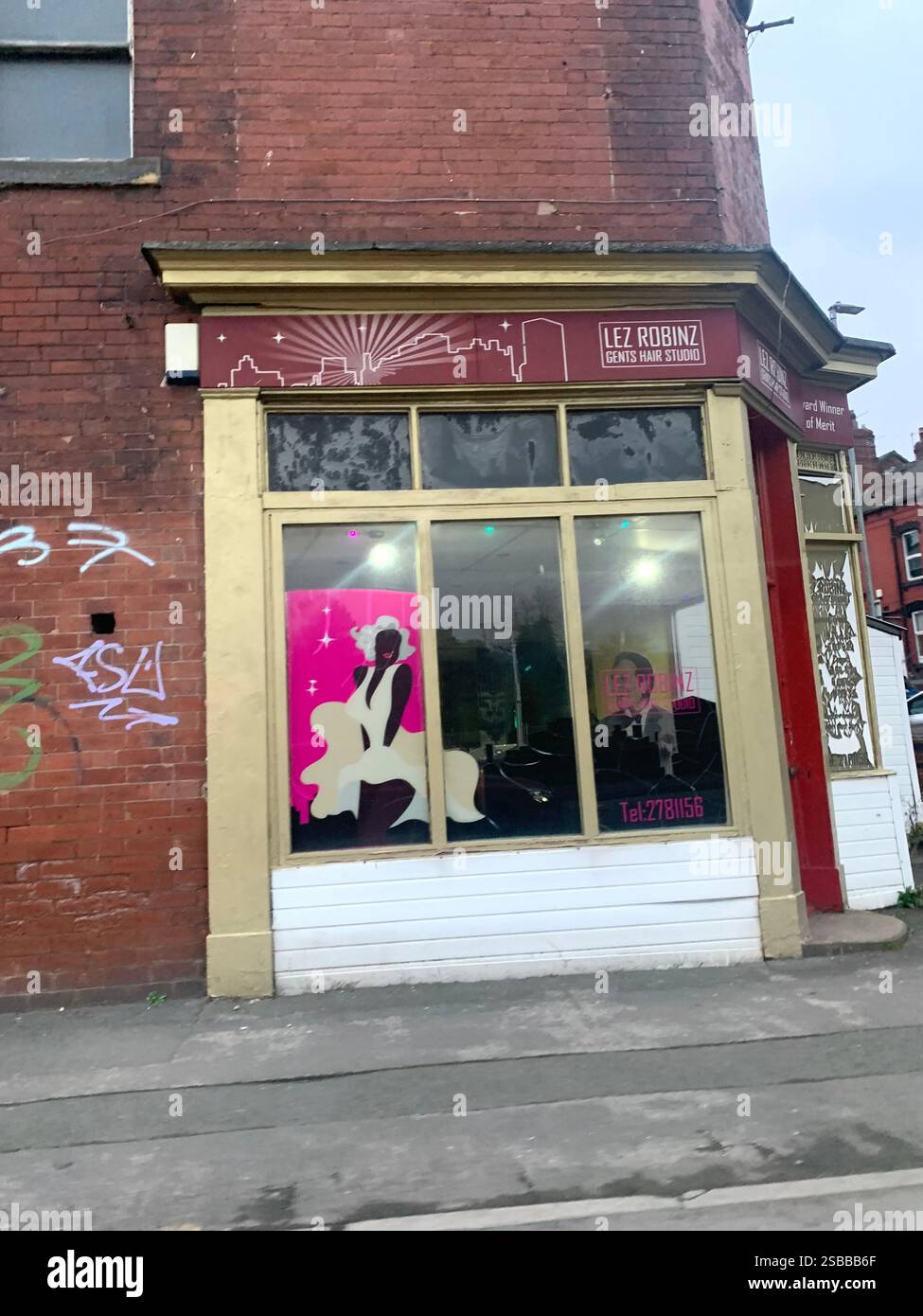 Leeds Yorkshire England UK shop shops town street people walk walking town life barbers restaurant cleaners Italian food barbers man with hat on walk - Smartphone Captured Stock Image