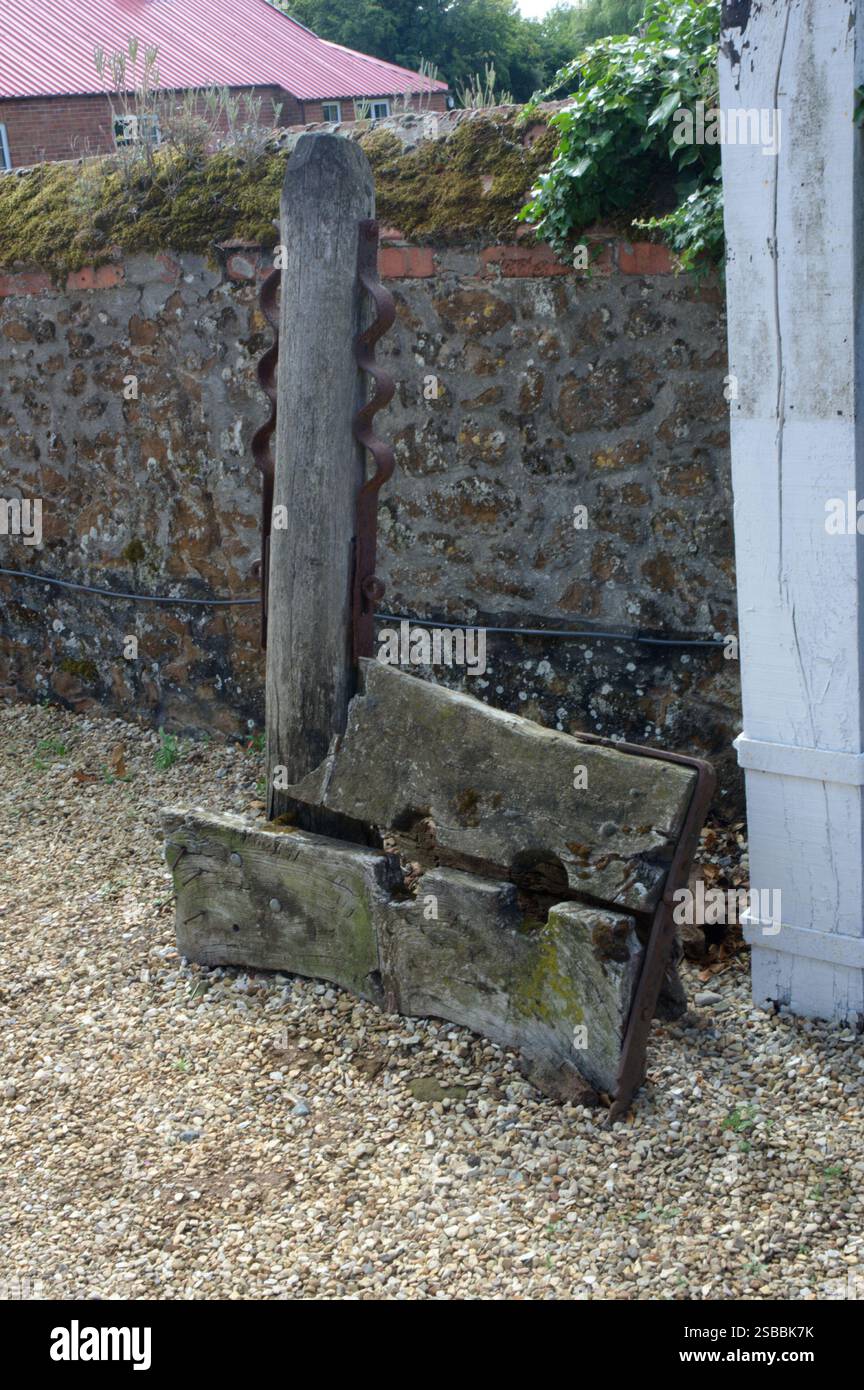 Stocks and whipping post outside the Gin Trap Inn, Ringstead. Norfolk, UK Stock Photo