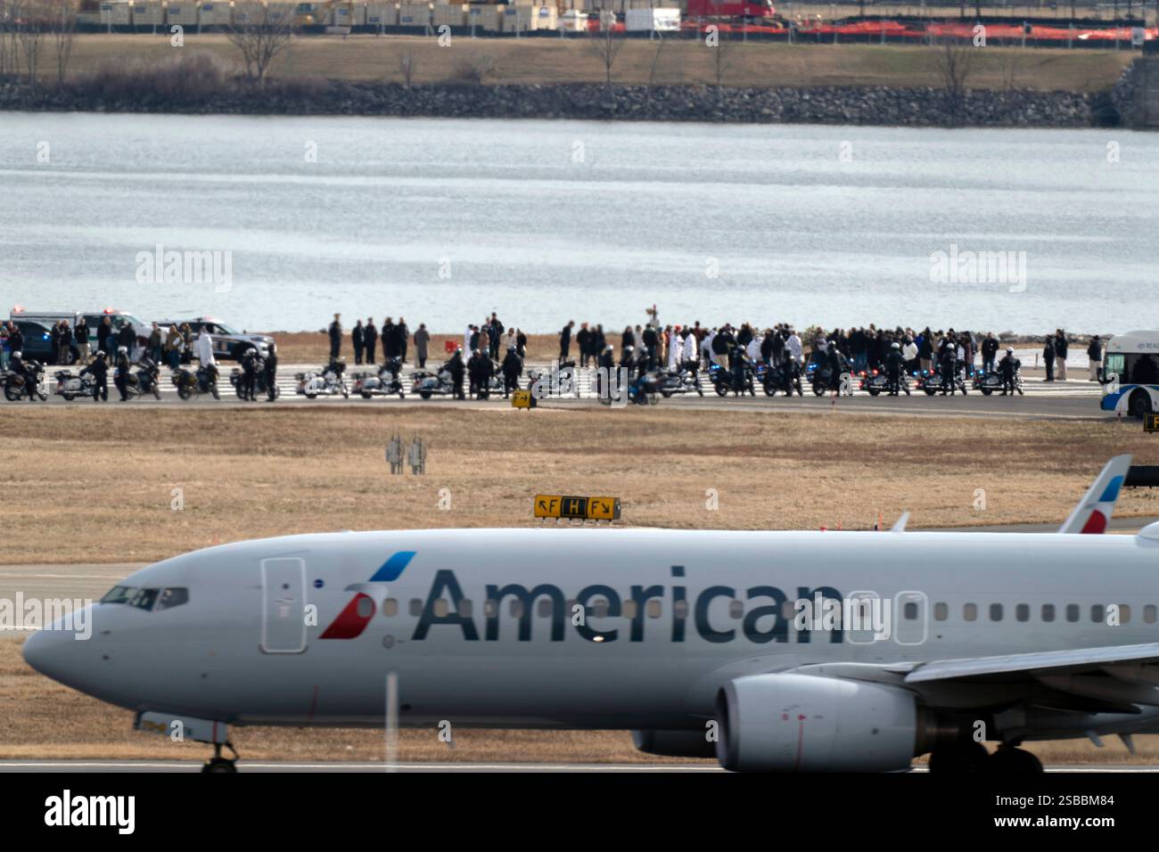 An American Airlines jet passes as families of the victims of a mid-air ...