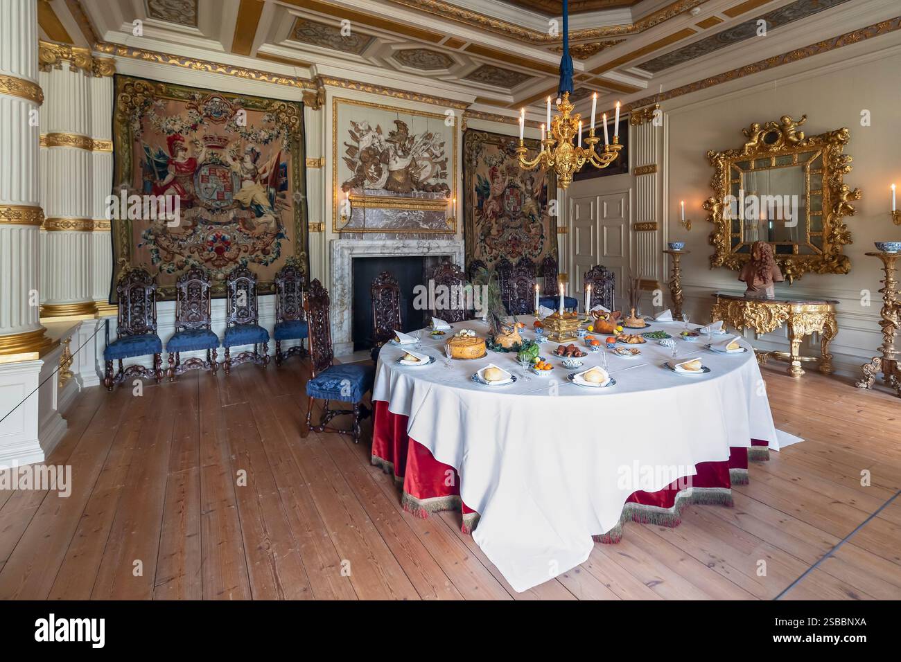 Interior of the dining room with a set table, a baroque mirror and wall ...