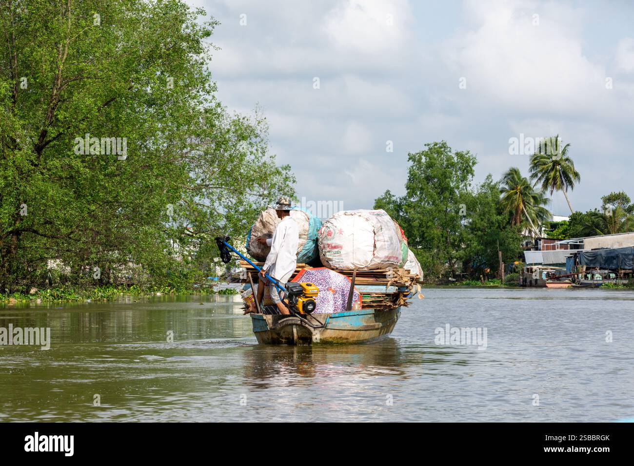 Can Tho, Vietnam - 9 November 2023: Traditional Boat on a Serene River in Chau Doc Stock Photo