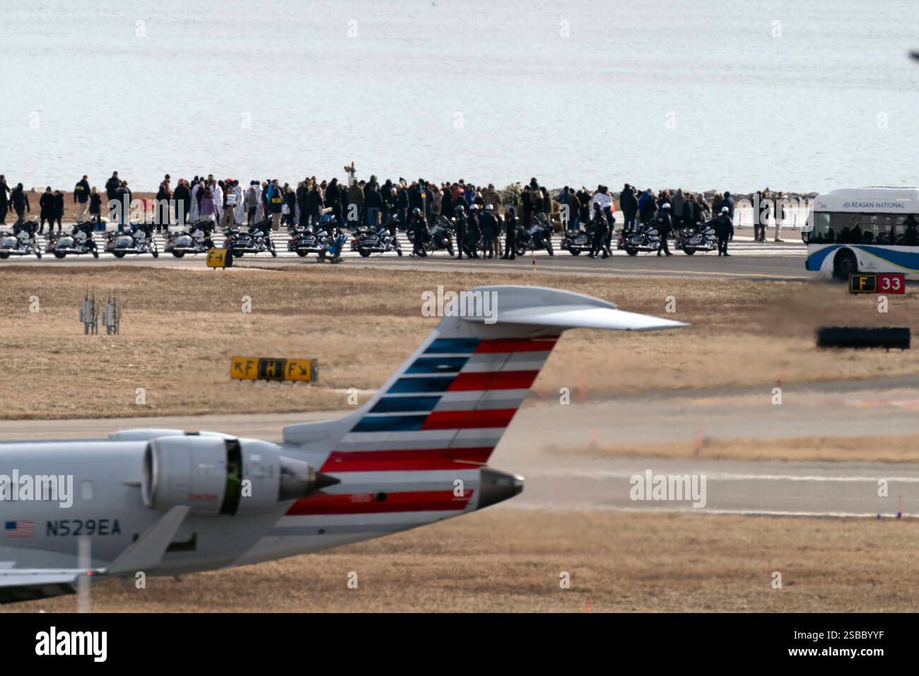 An American Airlines jet passes as family members of the victims of a ...