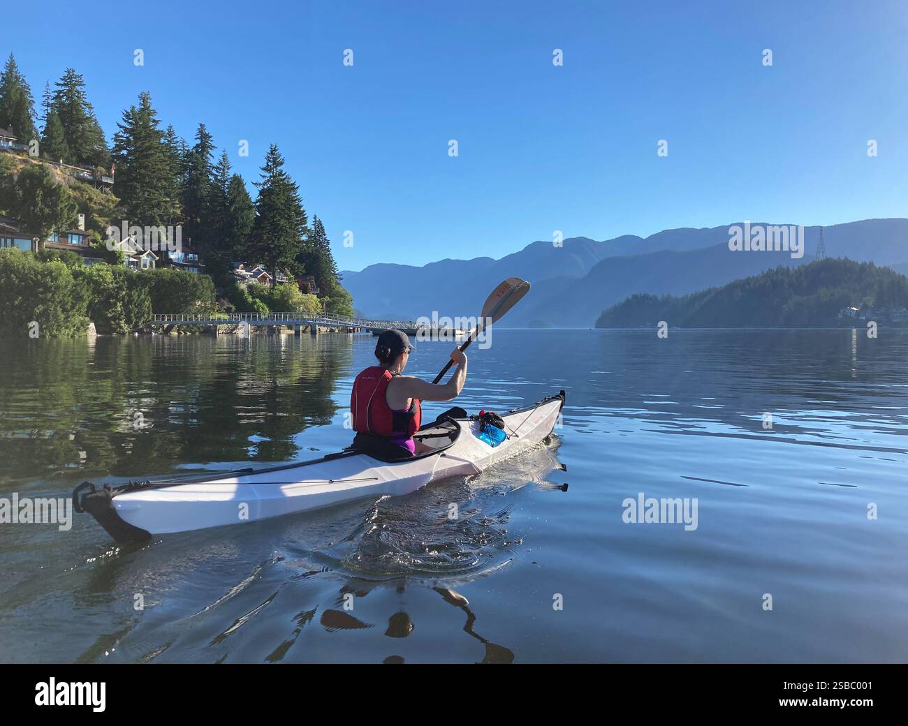 Woman in a kayak in Deep Cove, North Vancouver, British Columbia, Canada - Smartphone Captured Stock Image