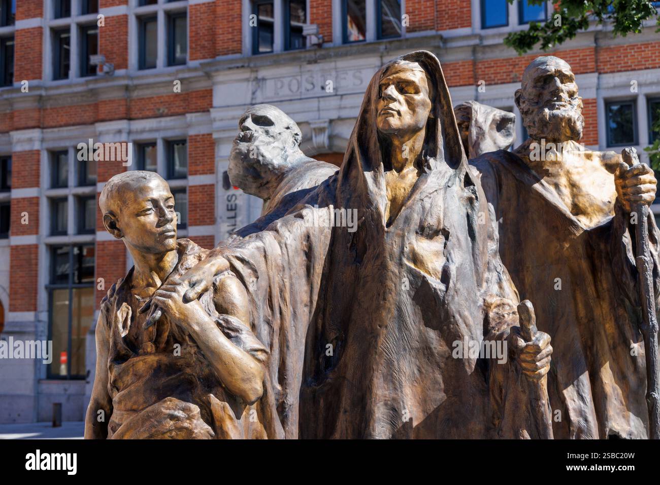 Child leading blind people, bronze statue by Guillaume Charlier, Tournai, Belgium Stock Photo