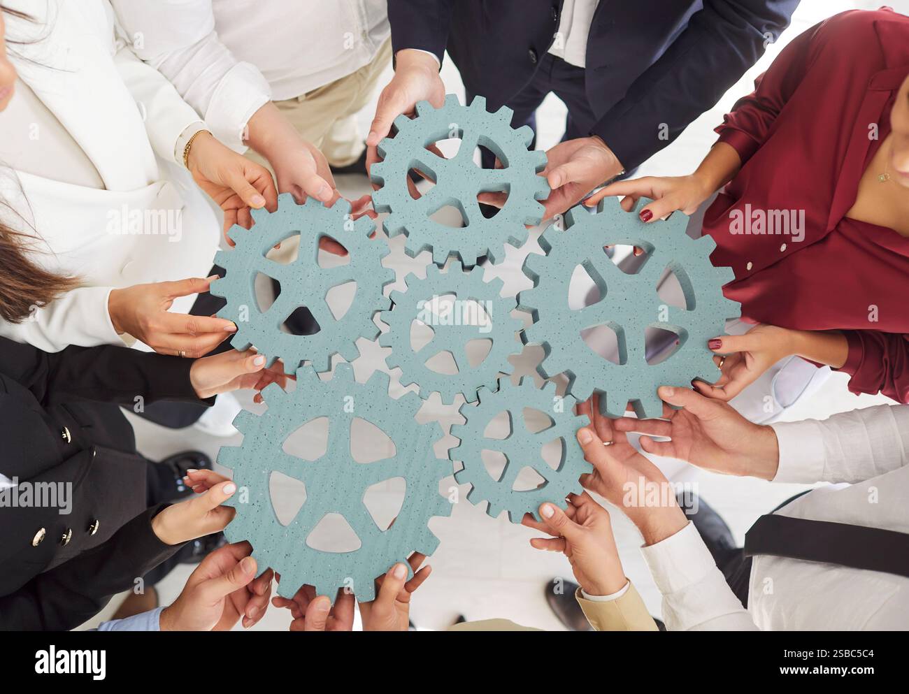 Hands together synergy teamwork hi-res stock photography and images - Alamy