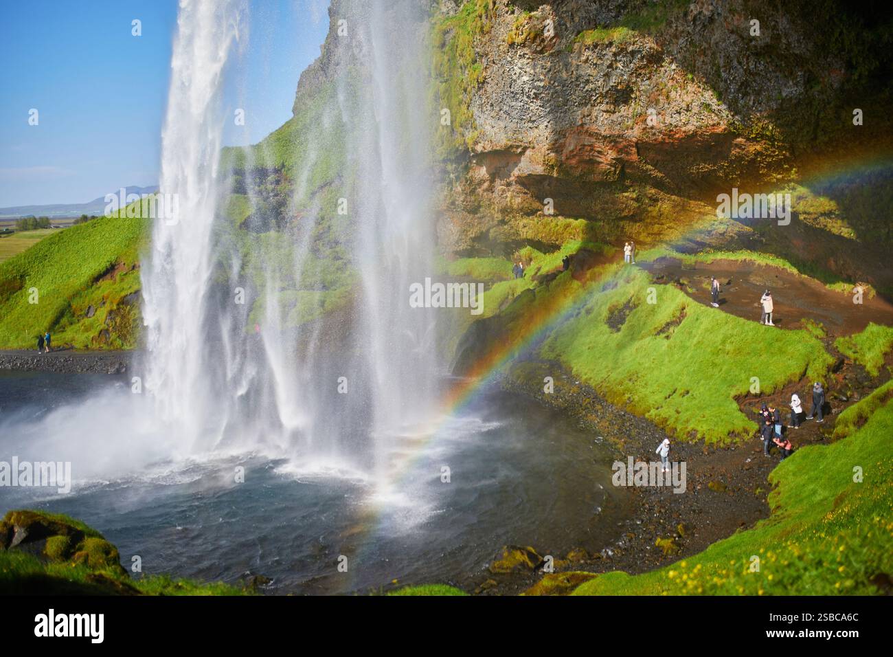Scenic view of Seljalandsfoss with rainbow, one of the biggest ...