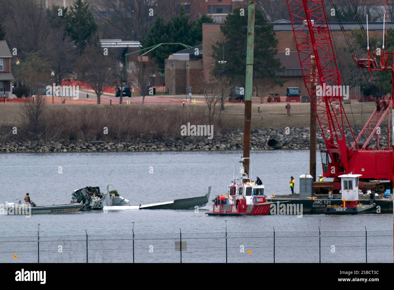 Rescue and salvage crews work near the wreckage of an American Airlines ...