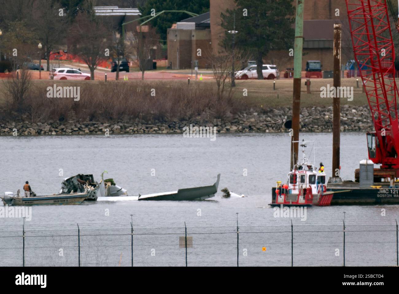 Rescue and salvage crews work near the wreckage of an American Airlines ...